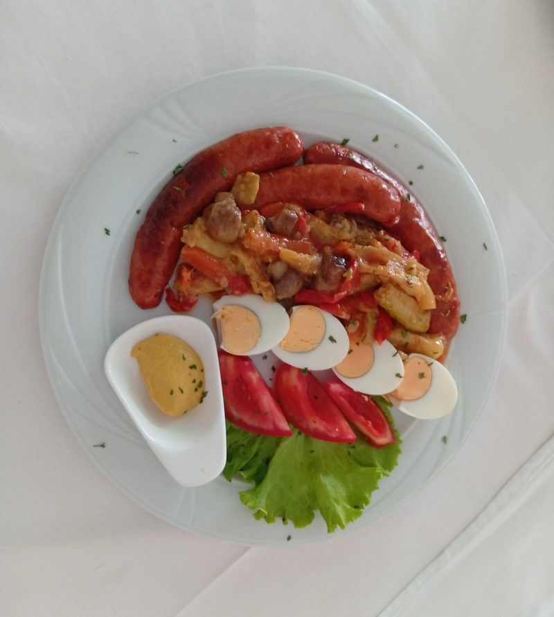 Bosnian kobasica grill plate with sausages, mixed vegetable stew, boiled eggs, fresh tomato and mustard, Banja Luka